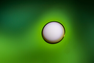 Oil drops in the water and milk create an artistic and imaginatively designed abstract background