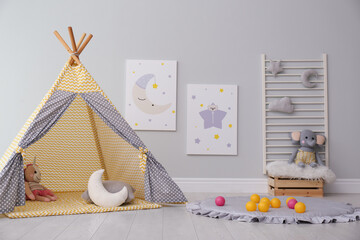 Stylish child's room interior with adorable paintings and play tent