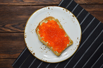 Sandwich with red salmon caviar. Healthy and satisfying natural food