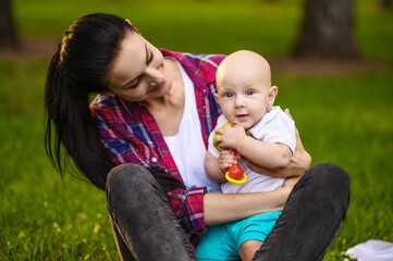 Portrait of mother and her baby in park