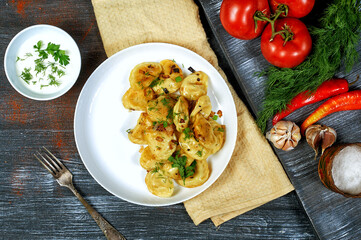 Dumplings with potatoes and onions on a plate . The view from the top