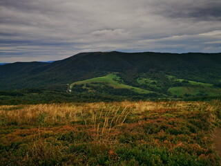 Autumn in the Bieszczady Mountains Poland. Cloudy sky over the Bieszczady Mountains. Mountain trails in the Bieszczady Mountains. Trekking in the Bieszczady Mountains. Mountain valley in the fog.