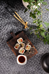 Roll with vegetables and fish paste with a sesame cap. Sushi menu bar. Japanese food Sushi served top view.