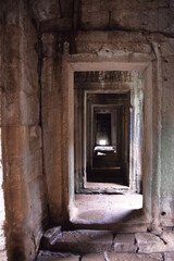 corridor of stone doors inside a Cambodian temple
