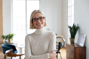 Profile picture of smiling young Caucasian businesswoman in glasses show leadership confidence...