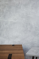 wooden table and stool with grey wall background