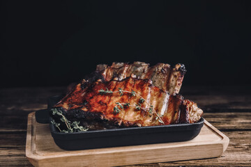 Tasty grilled ribs with thyme on wooden table. Food photography