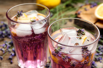 Fresh delicious lemonade with lavender on wooden table, closeup