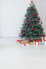 Christmas tree blue pine with gifts interior decor white room new year winter holiday