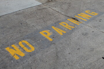 No Parking painted on a parking lot surface in a loading area