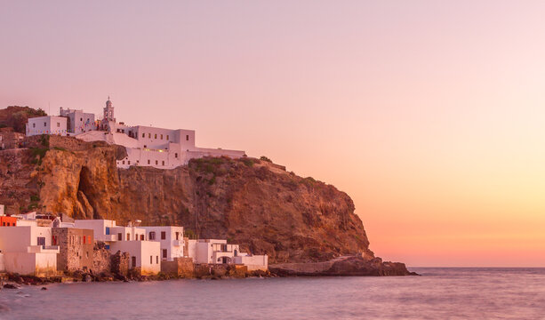 Nisyros, Greeec. Sunset in Mandraki village, the capital town of Nisyros island,Greece. In the background is the monastery of Panagia Spiliani.