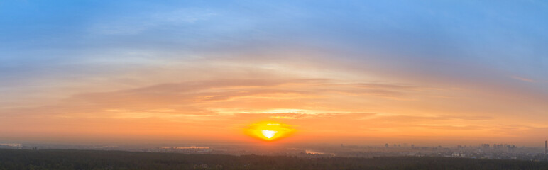 Yellow blue orange morning sky sunrise. Panorama.