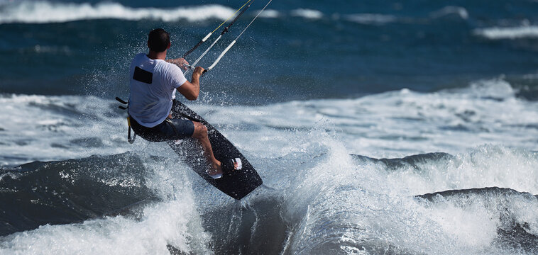 Athletic Man Jump On Kite Surf Board On A Sea Waves