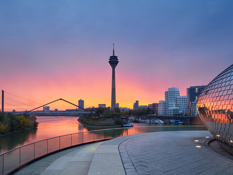 Rainy sunrise in the city of Dusseldorf in Germany. The urban landscape of the city of Düsseldorf. View of the Media Harbor during the golden hour