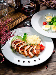 two course lunch grilled meat and fresh vegetable salad on the table