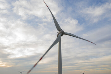 Wind turbine on a wind farm under windy and cloudy weather conditions