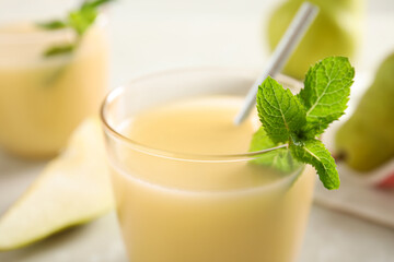 Tasty pear juice with mint in glass, closeup