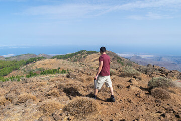 Young hiker walking between rocks