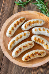 Grilled sausages on rustic plate