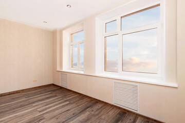 Fototapeta premium White empty room with two windows and wooden floor. Loft interior mock up. 3d render home blank space.