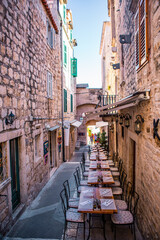 A small alley in Hvar island, at the coast of Croatia, summer time, on a sunny day.