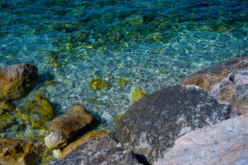 Green color Stones in the water. Abstract green closeup on transparent background. Beach vacation. Water splash. Foam water. Liquid texture background.