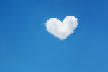 One lonely cloud in the shape of a heart in the bright blue sky