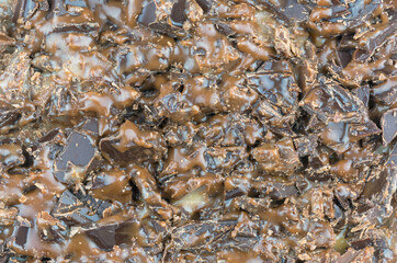 Crushed chocolate with filling as background, texture, pattern.