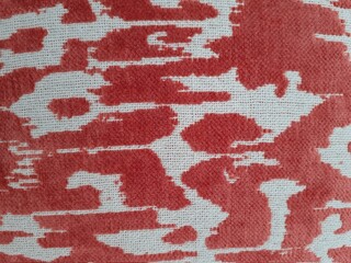 Background from a textile material red and white. Fabric with natural texture.