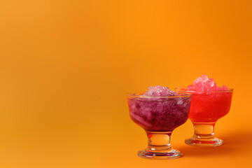 Shaving ice in glass dessert bowls on orange background, space for text