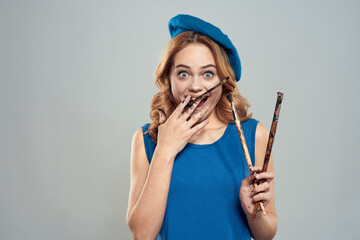 woman artist brush in hand blue beret dress hobby art lifestyle light background