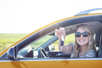 The blonde in the car. Attractive woman drives a car.
