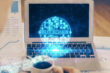 Double exposure of blockchain theme hologram and table with computer background. Concept of bitcoin...