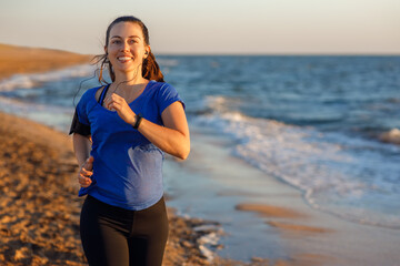 Fototapeta na wymiar Fitness woman running on the beach