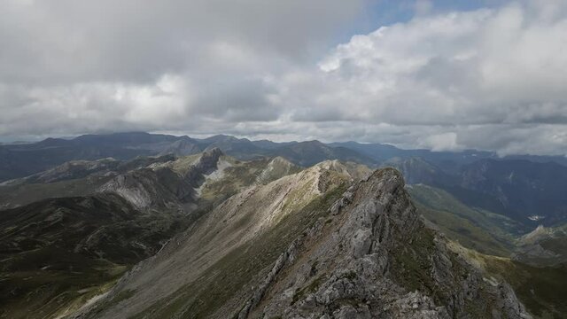 Mountain Ridge in the Summit of a Peak in Somiedo Natural Park, Asturias, Spain. Aerial 4k cinematic drone footage. Hiking Route During Cloudy Day.