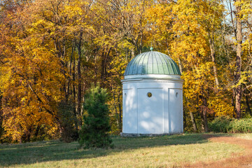 Old white gazebo in the autumn city park