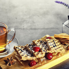 Sweet dessert with waffles and berries for tea at work.
