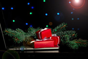 Laptop gifts black background christmas tree red light new year