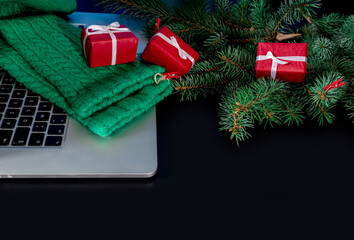 Laptop gifts black background christmas tree red green sock new year