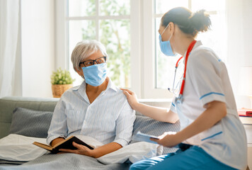 Fototapeta premium Doctor and senior woman wearing facemasks