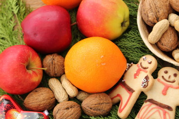 Christmas decoration with gingerbread figures, nuts and fruit