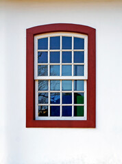 Colonial window on white facade