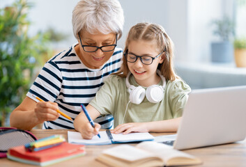 Fototapeta premium Girl doing homework or online education.