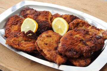 lots of crispy fried Viennese schnitzel with lemon