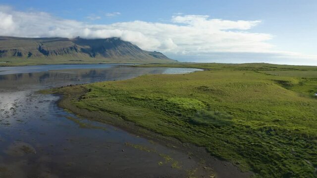 Aerial, pov, flat grassy landscape on a clear day, Iceland