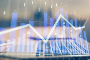 Financial chart drawing and table with computer on background. Multi exposure. Concept of international markets.