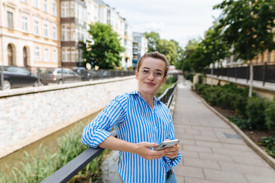 Relaxed young woman on an urban walkway