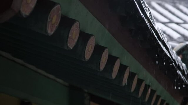 A close-up of traditional Korean houses on a rainy day.