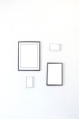 Empty paper frames on a white wall. Interior decor concept