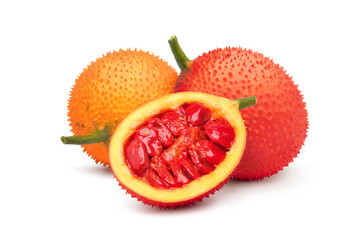Gac fruit with cut in half and green leaf isolated on white background.